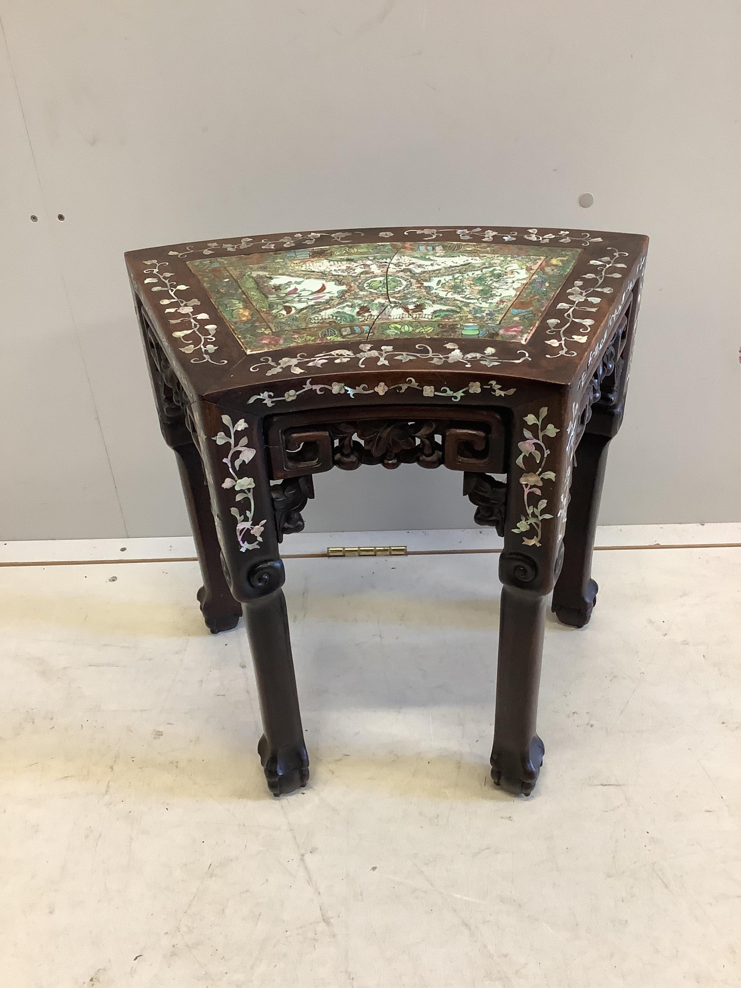 A Chinese mother of pearl inlaid hongmu vase stand, with famille rose porcelain inset top, (cracked), width 49cm, depth 31cm, height 47cm